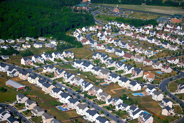 Aerial photo of a neighborhood of homes near a forest. (Photo courtesy of Chesapeake Bay Program).
