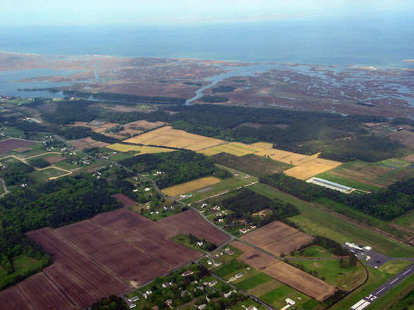 Three types of land use are displayed in this photo; Suburbs, agriculture, and wetlands lined up next to each other near Crisfield, MD.