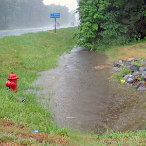 Stormwater ditch full during heavy rains. (Photo courtesy of Jane Hawkey, IAN).